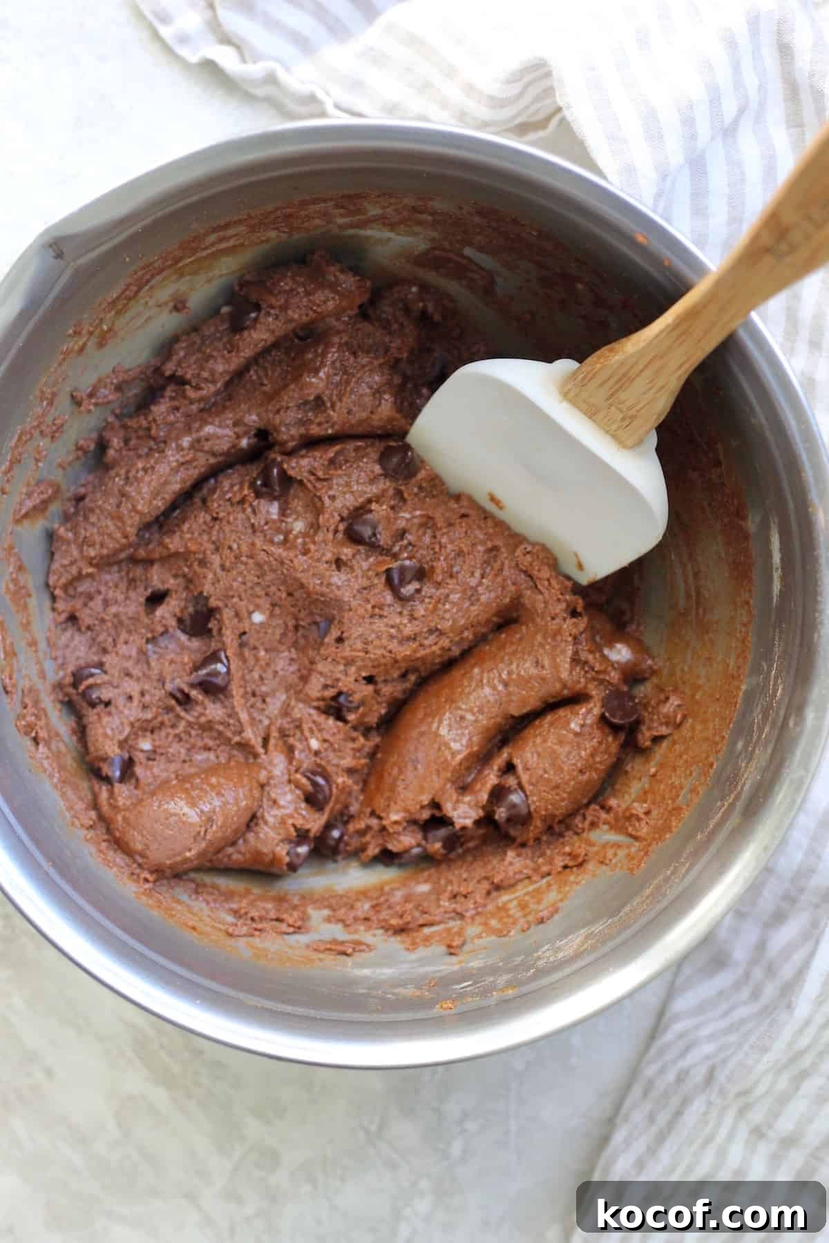 silver bowl with chocolate batter and white spatula