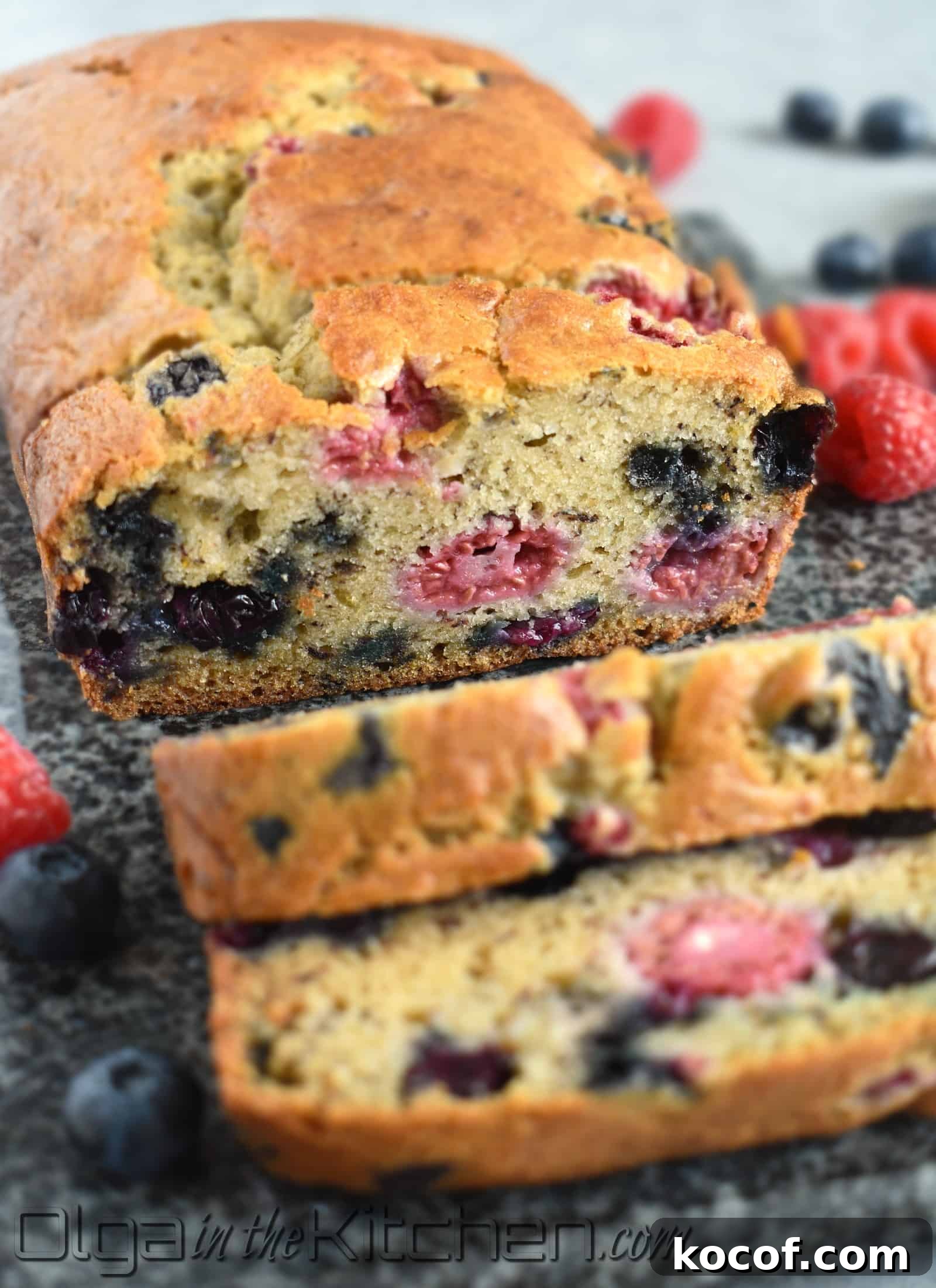 Slices of banana berry bread on a board.