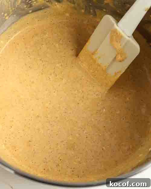 Mixing the cheesecake batter until smooth.