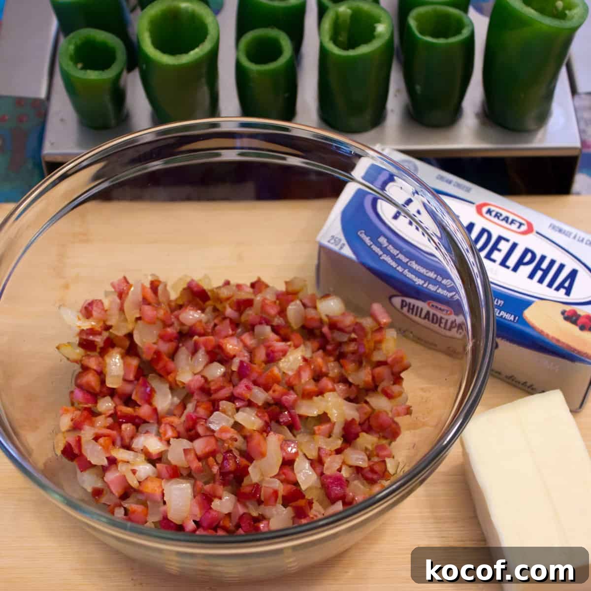 Sautéed onions and diced chorizo in a glass bowl.