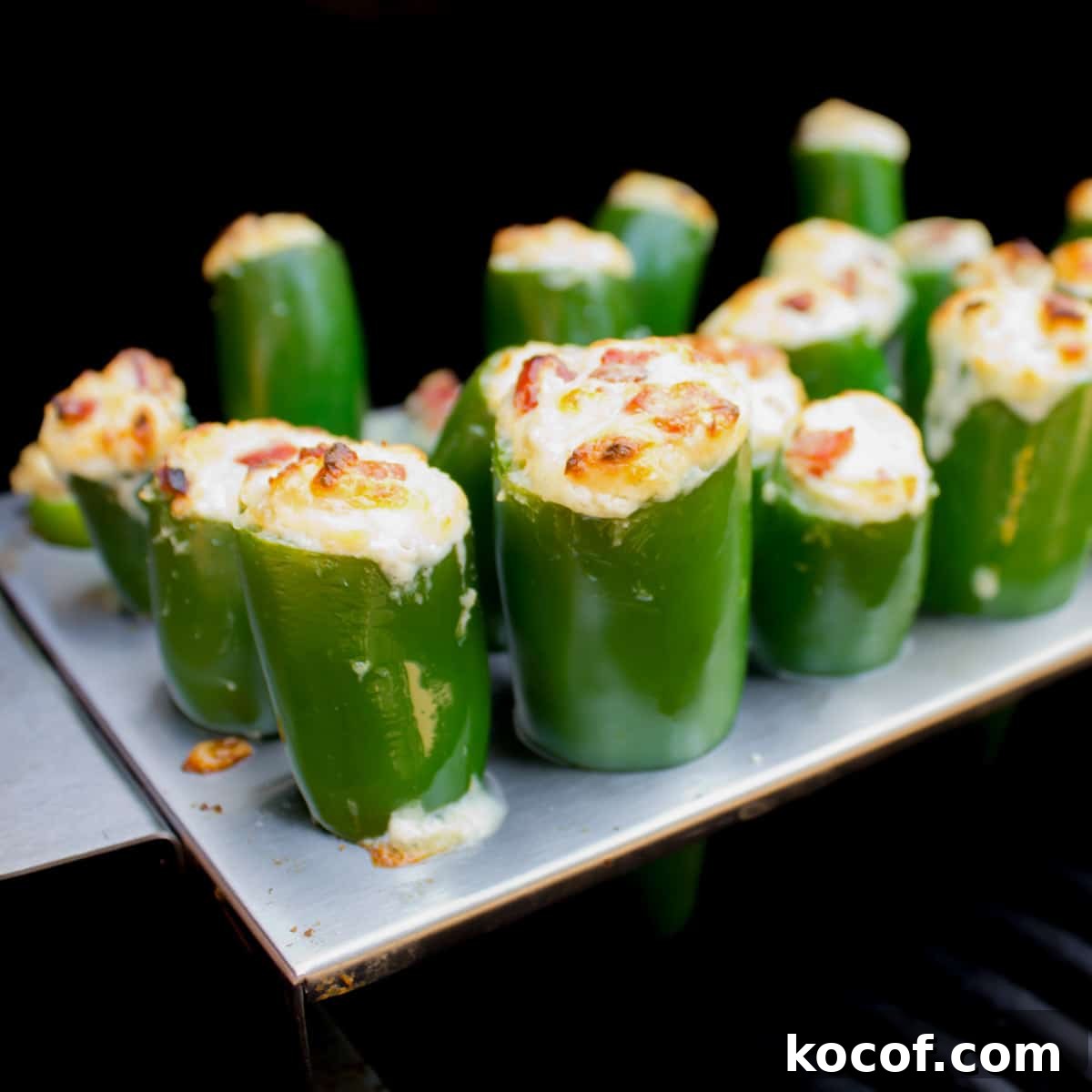 Stuffer jalapeno peppers on a grill.
