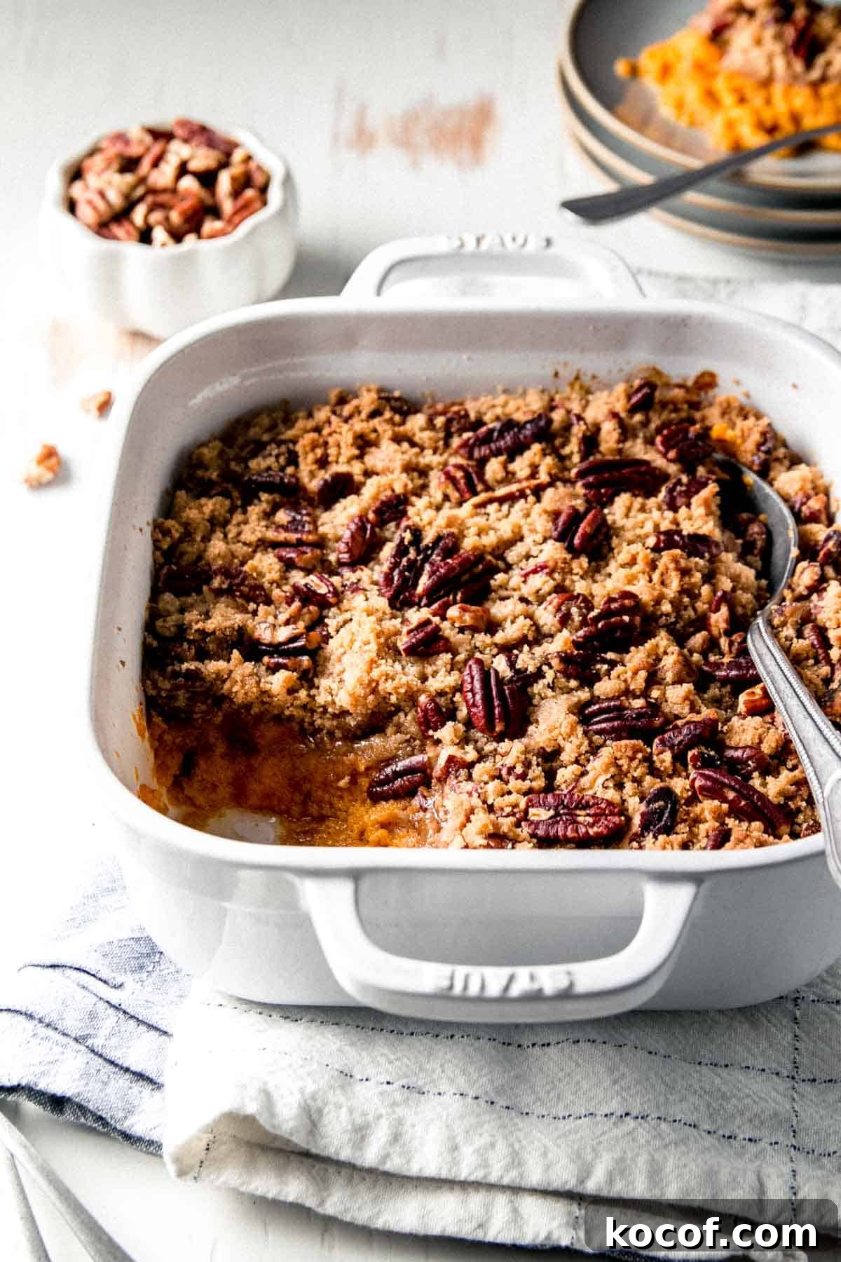 Gluten free sweet potato casserole in white dish with scoop removed.