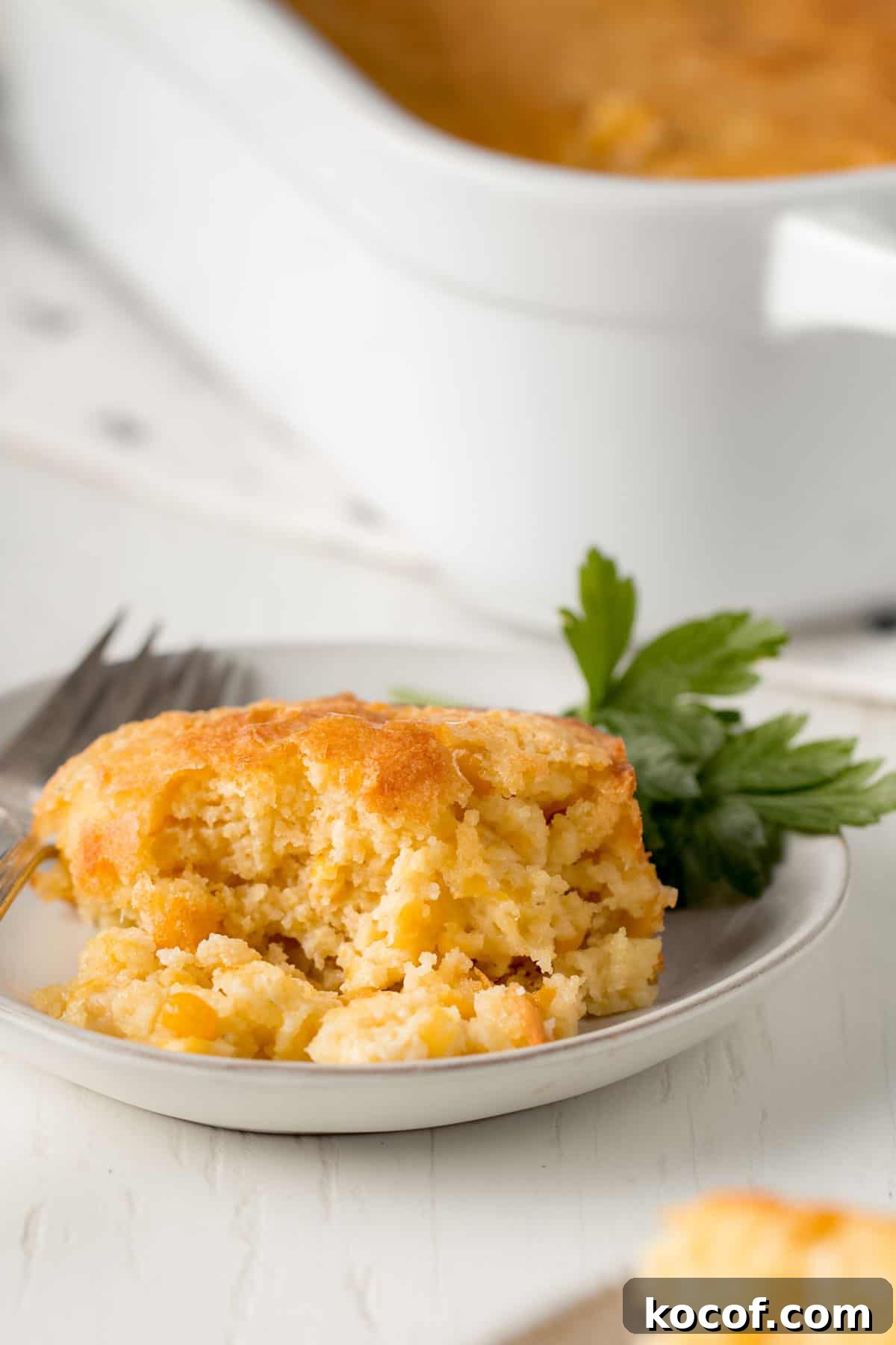Scoop of gluten free corn casserole on a small plate.