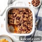Gluten free sweet potato casserole in white dish with scoop removed.