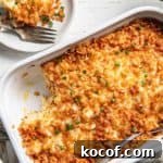Gluten-free Hashbrown Casserole in a white dish, scoop removed on a plate.
