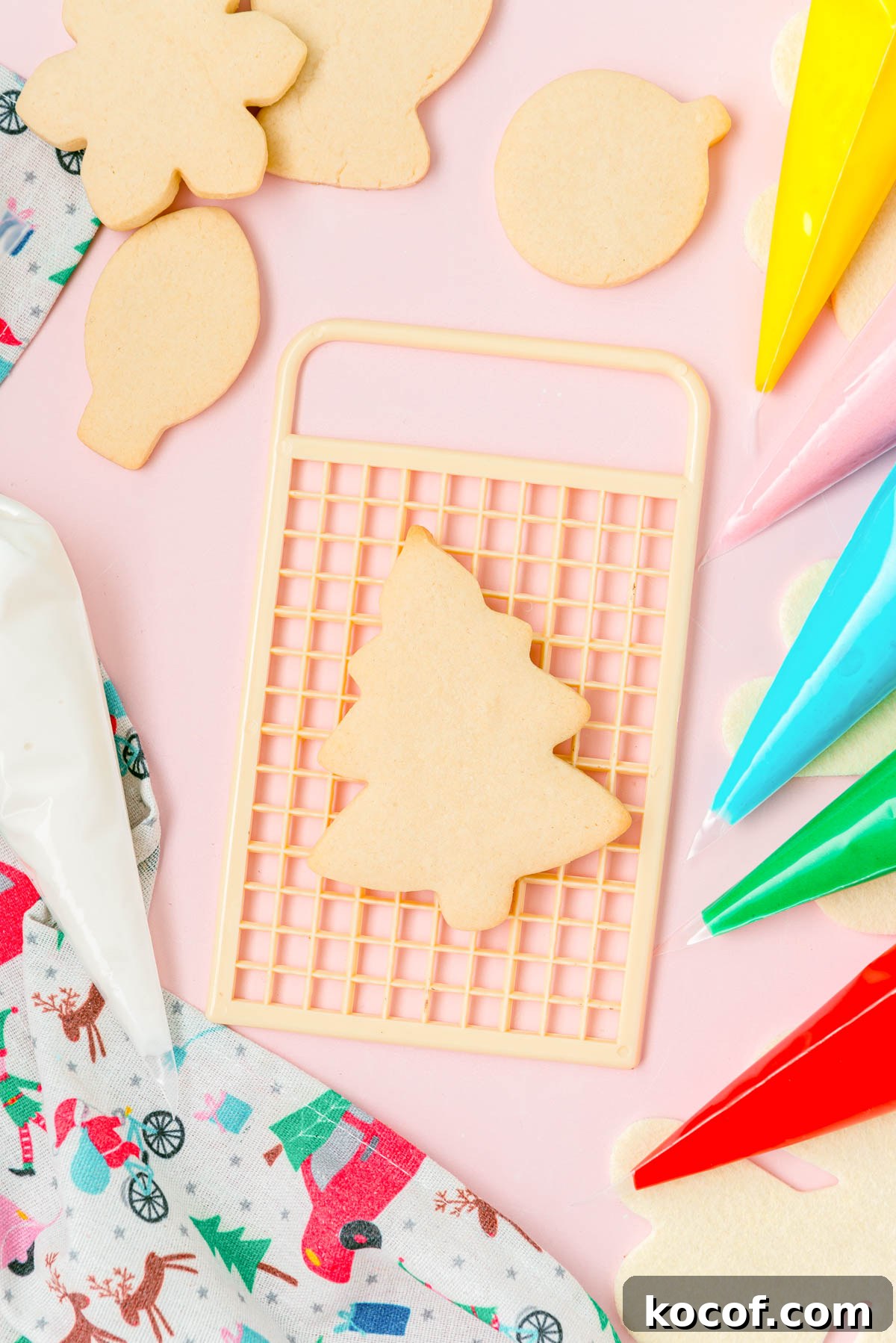 Overhead photo of cutout sugar cookies on a board ready to be frosted.